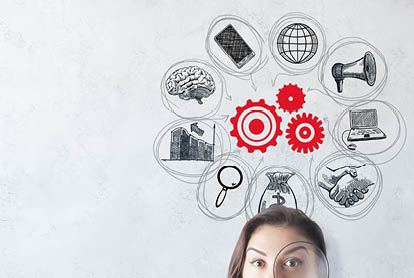Portrait of surprised young european woman with magnifier on concrete background with business sketch  Startup and teamwork concept